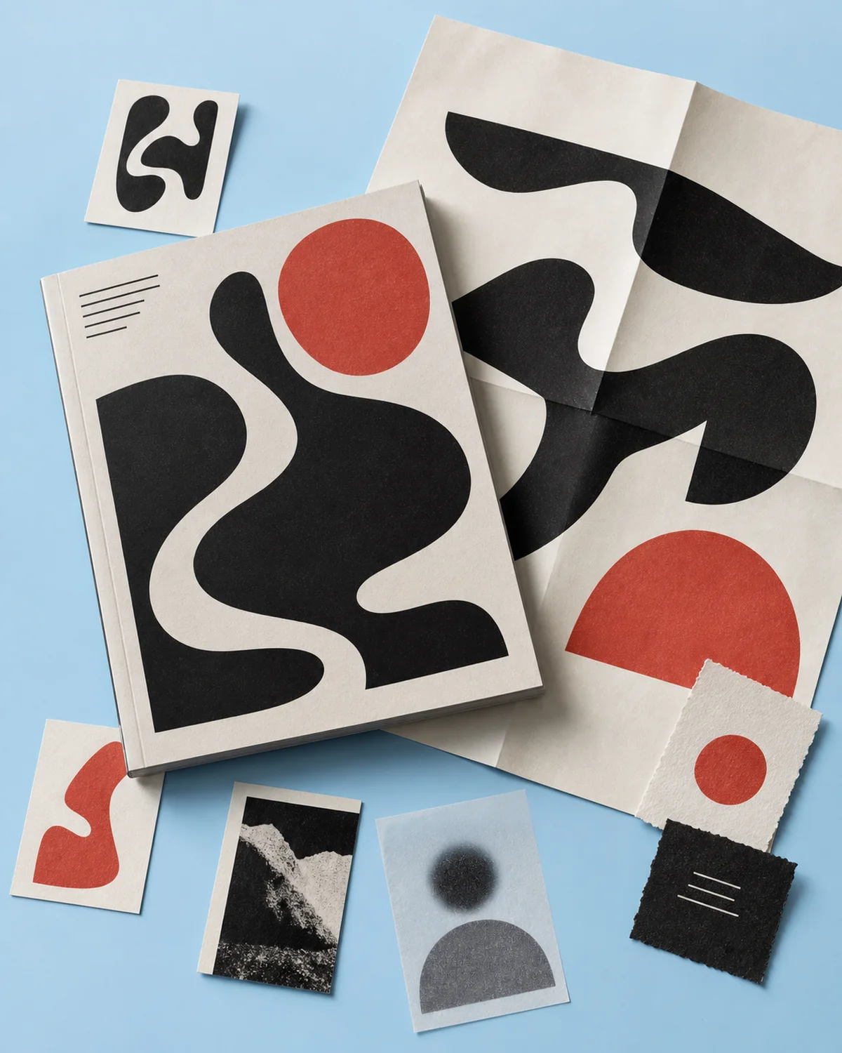 Abstract culture magazine and folded poster on a blue surface